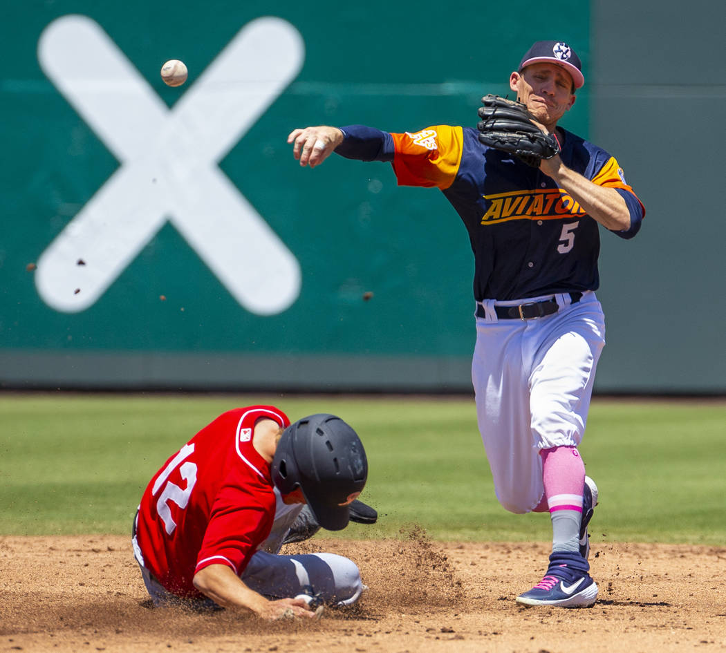 Tacoma Rainiers runner Connor Kopach (12) slides into second base late as Aviators second basem ...