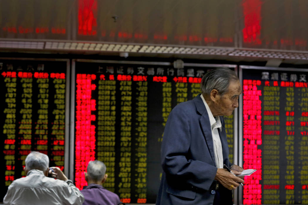 Chinese investors monitor stock prices at a brokerage house in Beijing, Monday, May 13, 2019. S ...