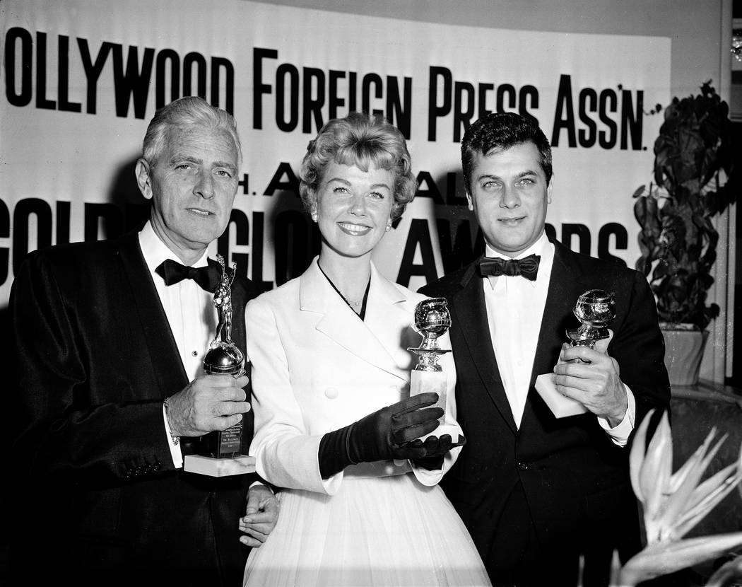 Actress Doris Day, with Tony Curtis, right, and Buddy Adler pose with their awards presented to ...