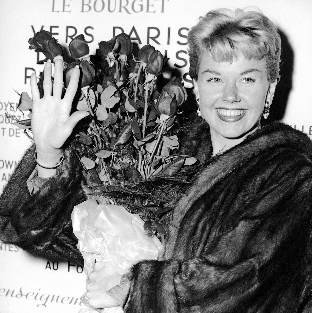 Actress and singer Doris Day holds a bouquet of roses at Le Bourget Airport in Paris, April 15, ...