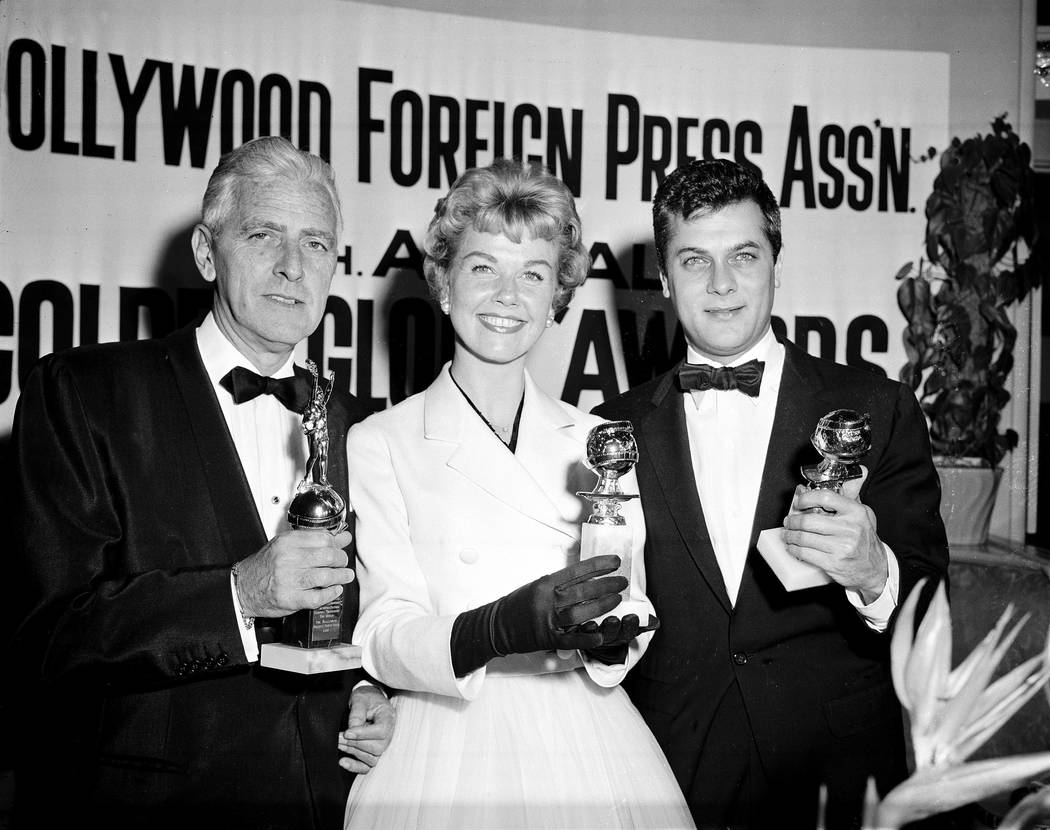 Actress Doris Day, center, Tony Curtis, right, and Buddy Adler pose with their awards presented ...