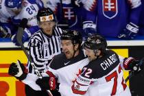 Canada's Mark Stone, left, celebrates with Canada's Thomas Chabot, right, after scoring his sid ...