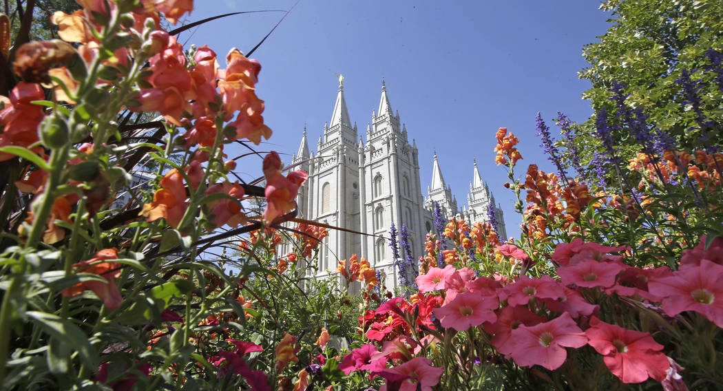 FILE - This Aug. 4, 2015 file photo, flowers bloom in front of the Salt Lake Temple, at Temple ...