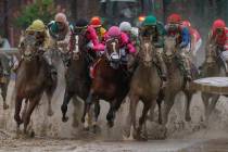 Luis Saez riding Maximum Security, second from right, goes around turn four with Flavien Prat r ...
