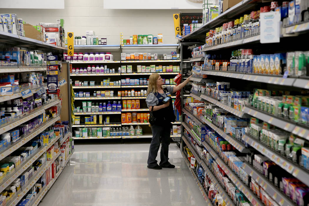 Health and Beauty Department Manager Jeanne Reed scans items at Walmart at 2310 E. Serene Ave. ...
