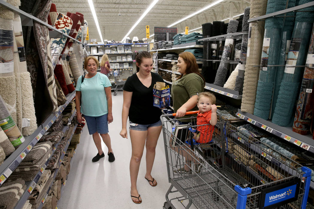 Brittanee Bradley, second from left, shops with her son Daymon 1, mother Kim Debusk, right, and ...