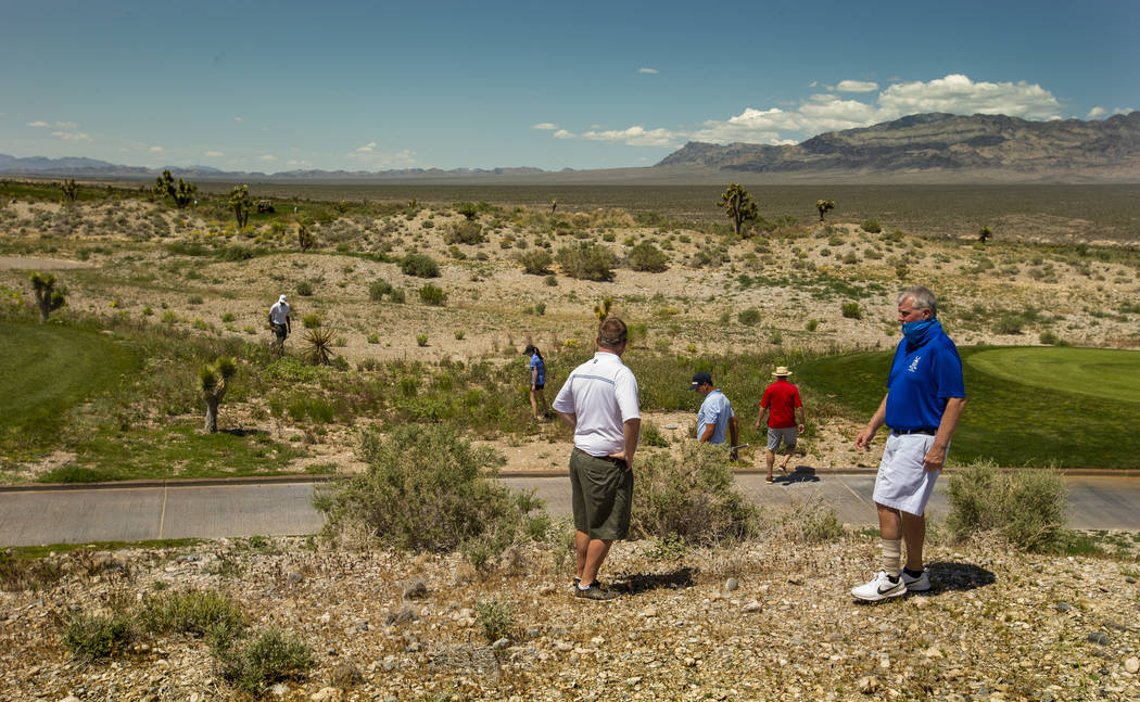 Golfers and others help to look for a lost ball off the fairway during a PGA US Open qualifying ...