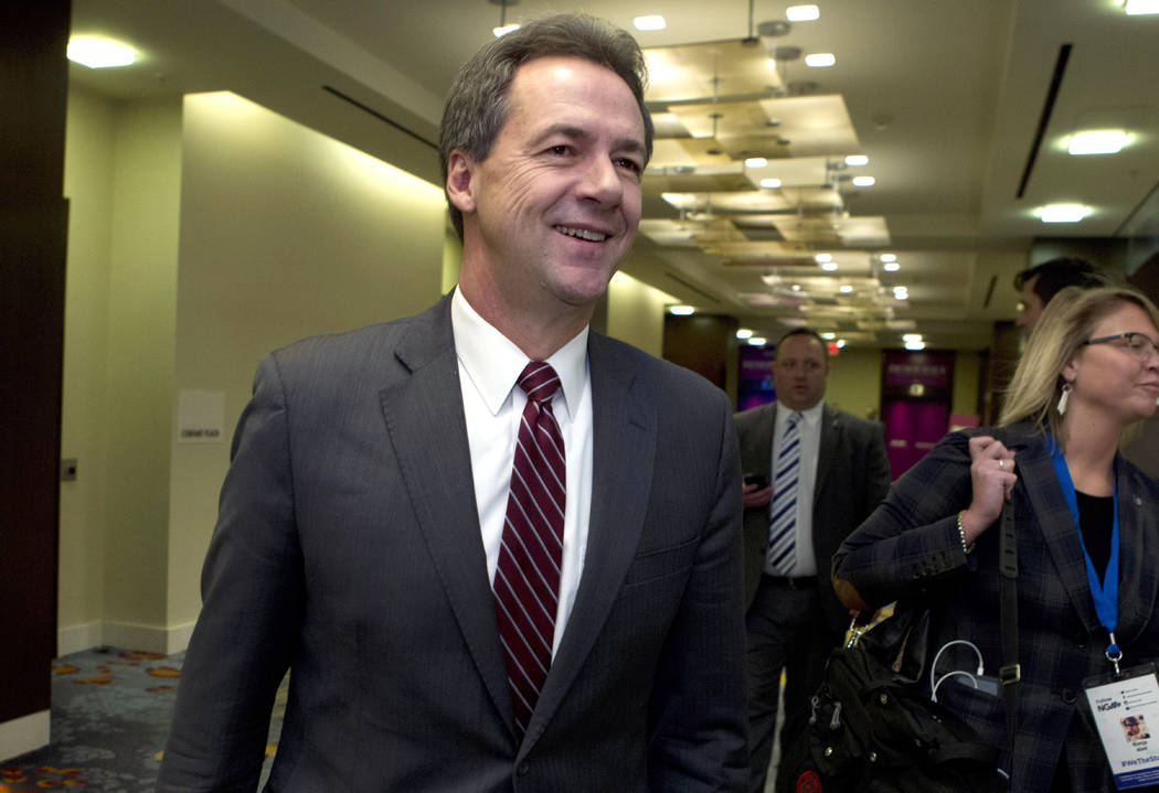 Montana Gov. Steve Bullock walks to a Feb. 23, 2019, meeting during the National Governors Asso ...