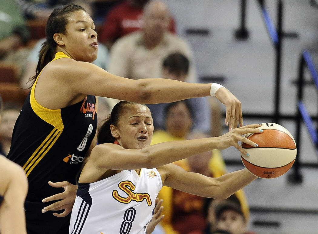 Tulsa Shock's Elizabeth Cambage, pressures Connecticut Sun's Mistie Bass, bottom during the fir ...