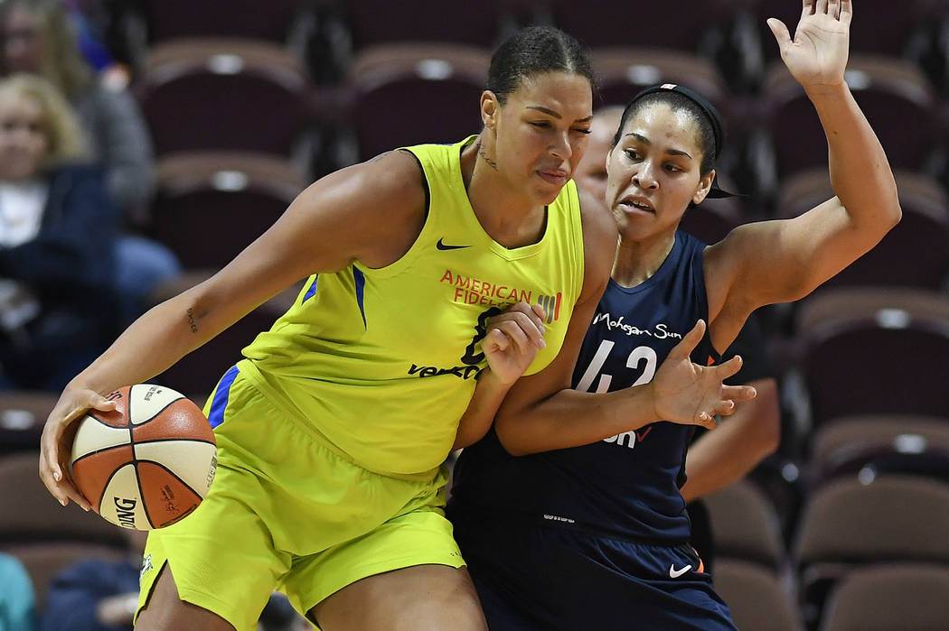 In this May 8, 2018, file photo, Dallas Wings' Liz Cambage, left, drives against Connecticut Su ...