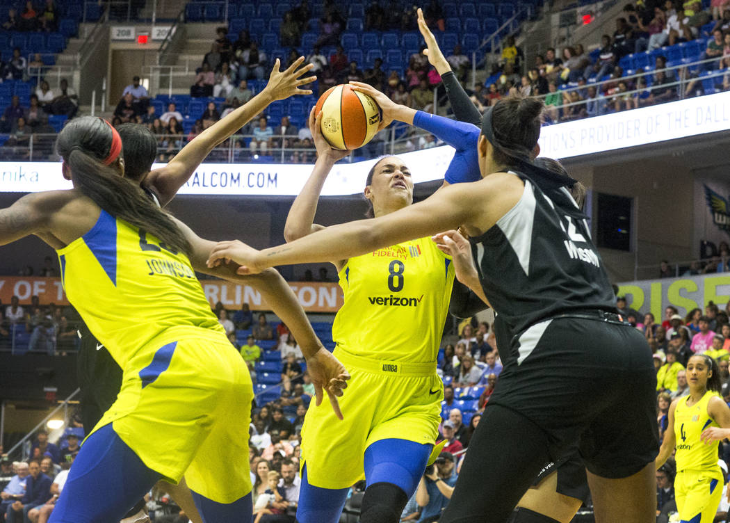 Dallas Wings center Liz Cambage (8) attempts to shoot a basket over Las Vegas forward A'ja Wils ...