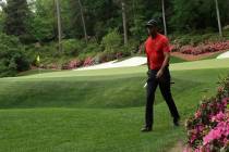 Tiger Woods walks to the 14th hole during the final round for the Masters golf tournament, Sund ...