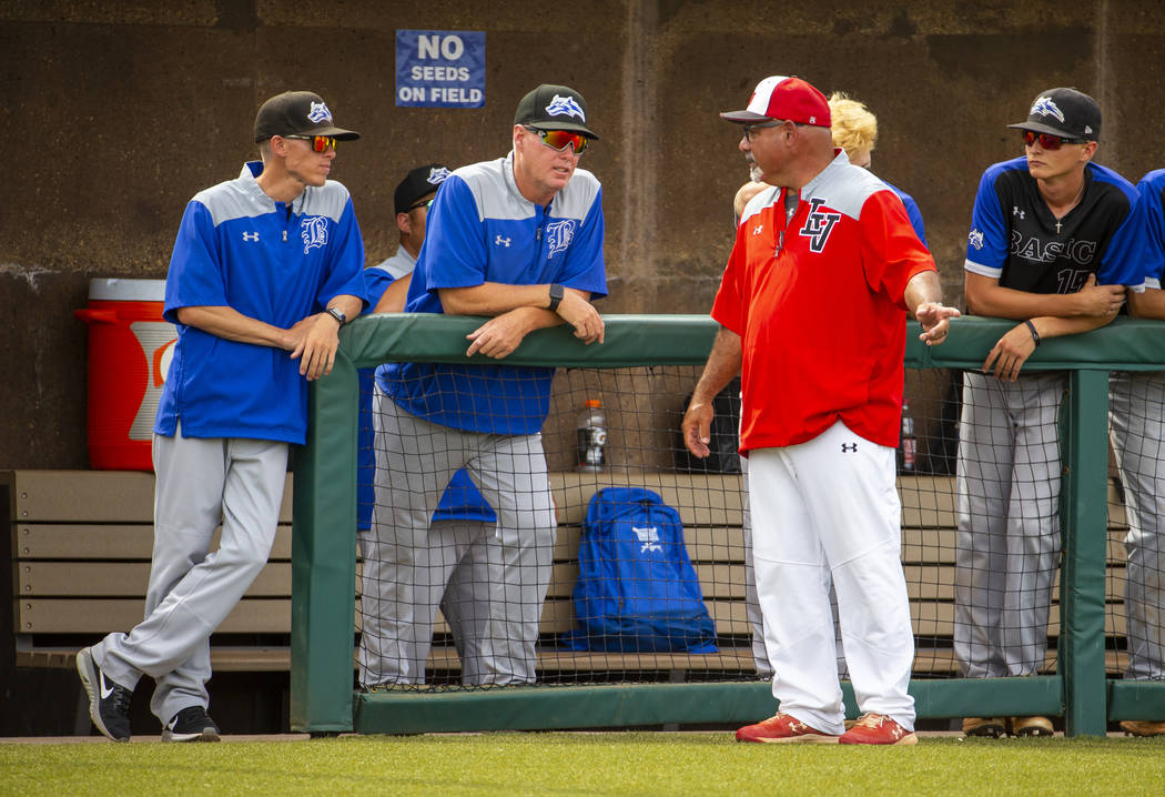 Longtime Las Vegas High coach Sam Thomas (right) talks up Basic coaches at an inning change dur ...