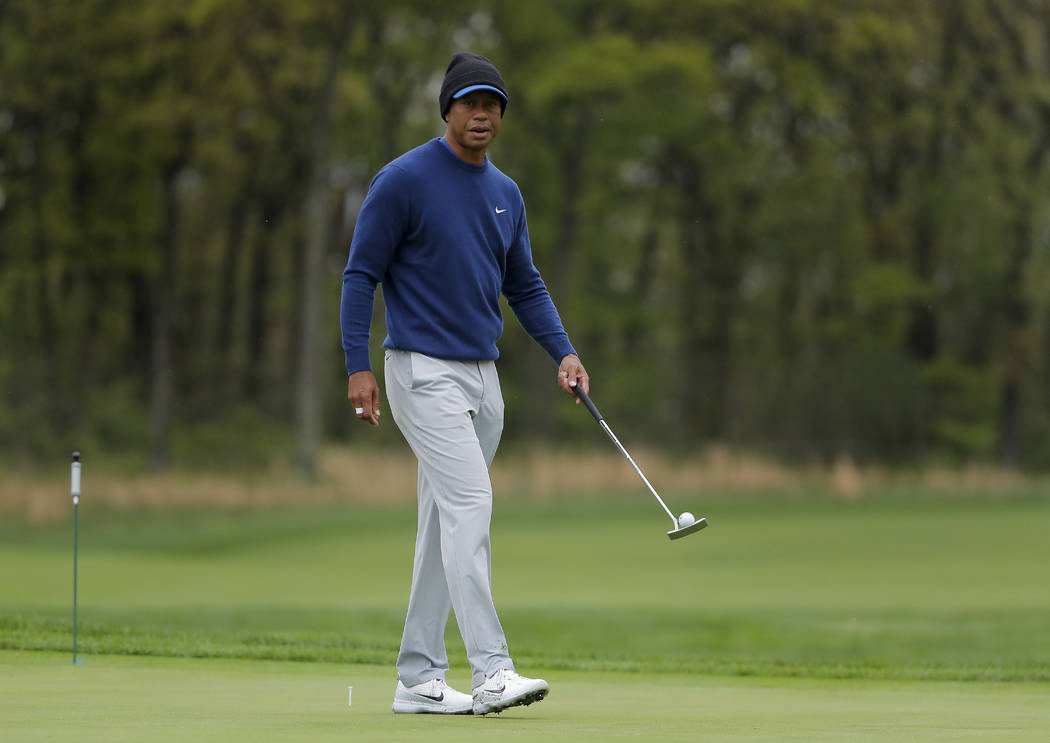 Tiger Woods walks along the ninth green during a practice round for the PGA Championship golf t ...