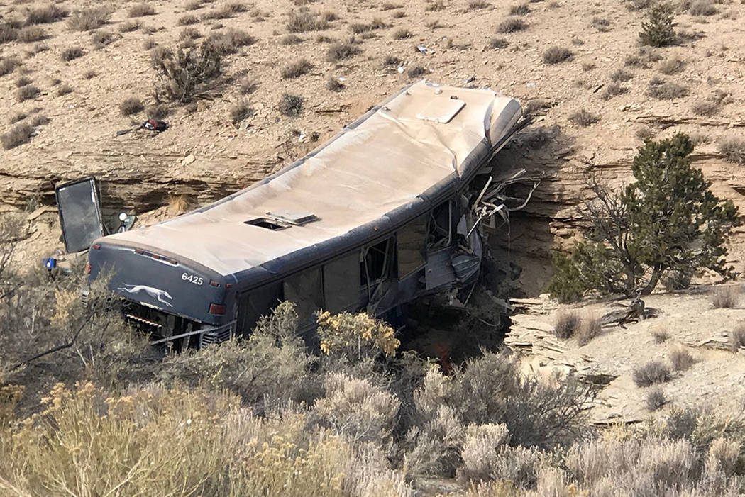 The aftermath of a late-Sunday Greyhound bus crash is seen on Monday, Jan. 1, 2018 in Emery Cou ...