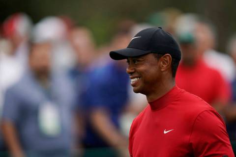 Tiger Woods smiles as he walks off the seventh tee during the final round for the Masters golf ...