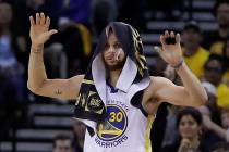 Golden State Warriors' Stephen Curry celebrates a teammate's score during the second half of Ga ...
