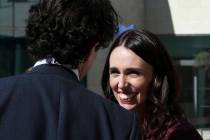 New Zealand Prime Minister Jacinda Ardern, right, smiles prior to give a press conference, at t ...