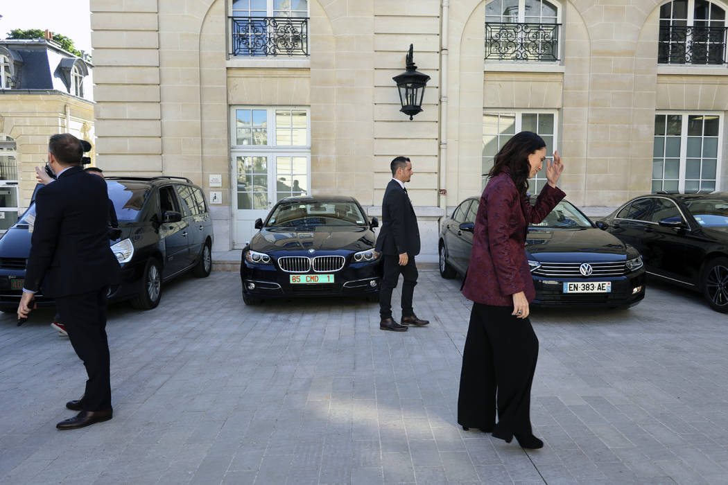 New Zealand Prime Minister Jacinda Ardern, right, leaves after a press conference, at the OECD ...