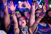 Festivalgoers dance to the sounds of American DJ Kaskade on day one of the Electric Daisy Carni ...