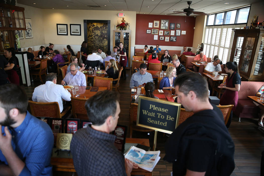Customers wait in line to be seated during lunch at Archi's Thai Bistro in Las Vegas, Thursday, ...