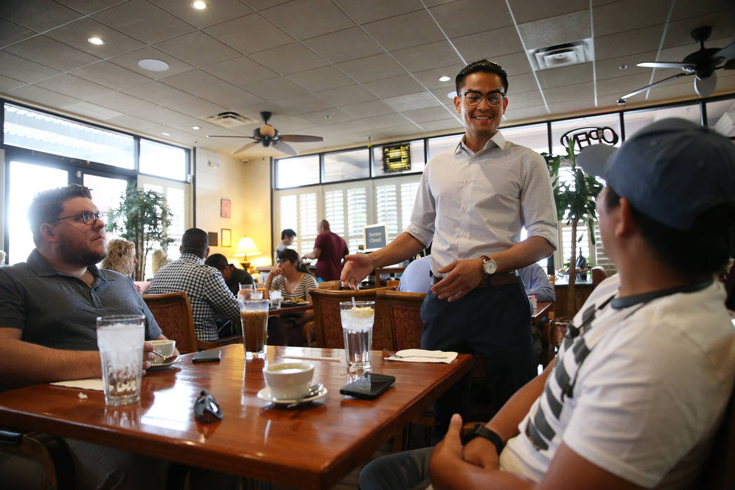 Ronnakon Silpasuvun, center, owner of Archi's Thai Bistro, speaks with Cameron Belt, left, and ...