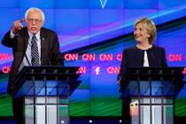 In this Tuesday, Oct. 13, 2015, file photo, Sen. Bernie Sanders, of Vermont, left, speaks as Hi ...