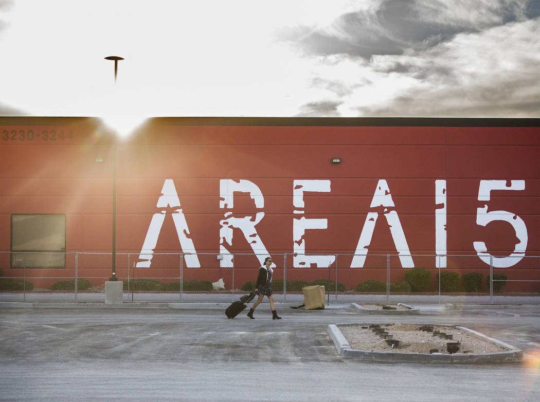 Jessica Fisher walks across the parking lot of AREA15, an experiential retail and entertainment ...