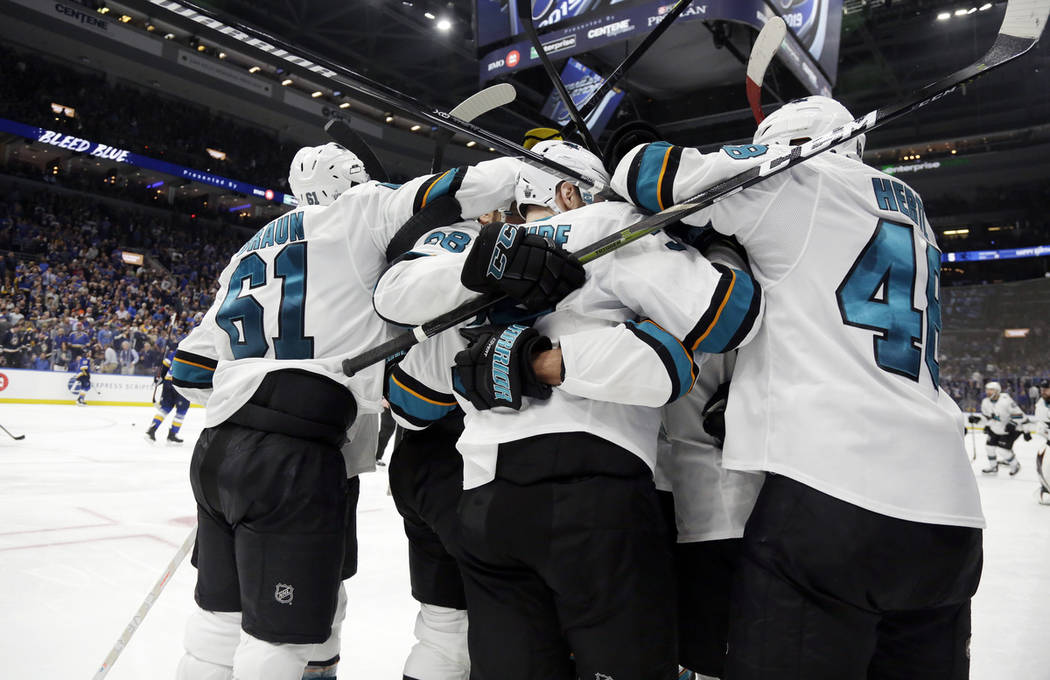 San Jose Sharks players celebrate after beating the St. Louis Blues in overtime in Game 3 of th ...
