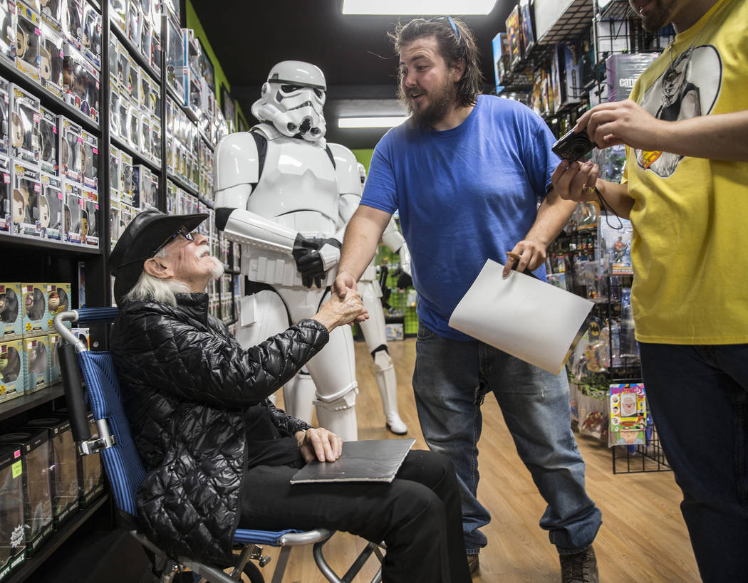 Colin Cantwell, left, concept artist and model builder for the original Star Wars movies, shake ...