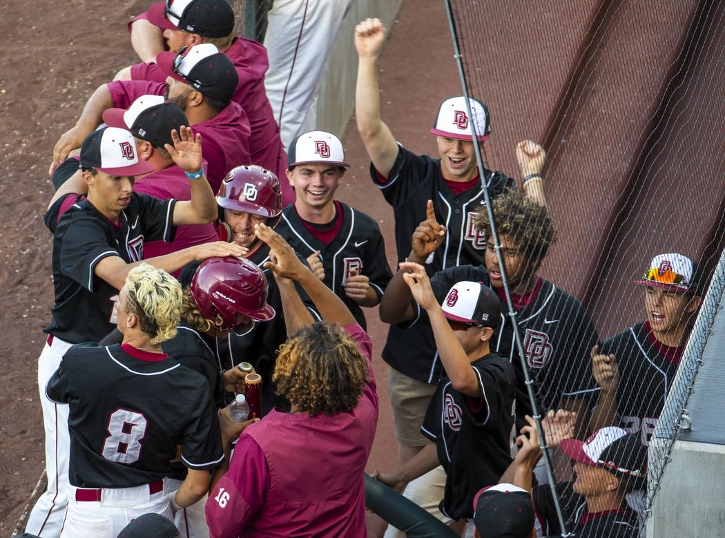 Desert Oasis players celebrate another run over Reno during their Class 4A state baseball tourn ...