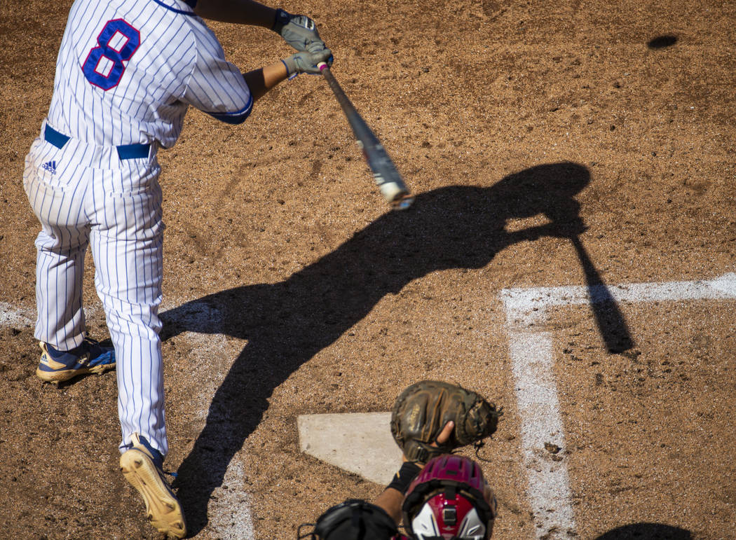 Reno batter Gunner Gouldsmith has his shadow cast on the infield as he faces a Desert Oasis pit ...