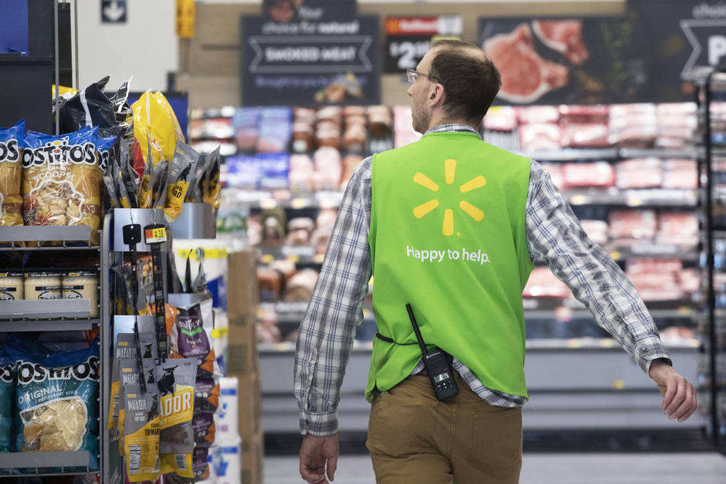 A Walmart associate works April 24, 2019, at a Walmart Neighborhood Market in Levittown, N.Y. W ...