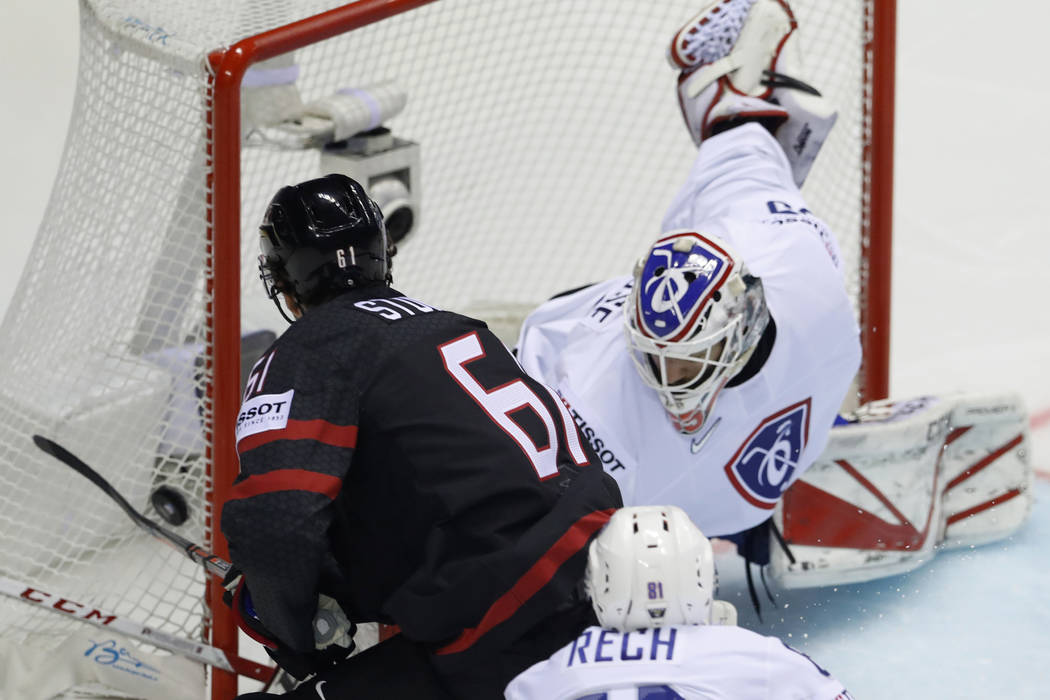Canada's Mark Stone, left, fails to score past Henri Corentin Buysse of France, right, during t ...