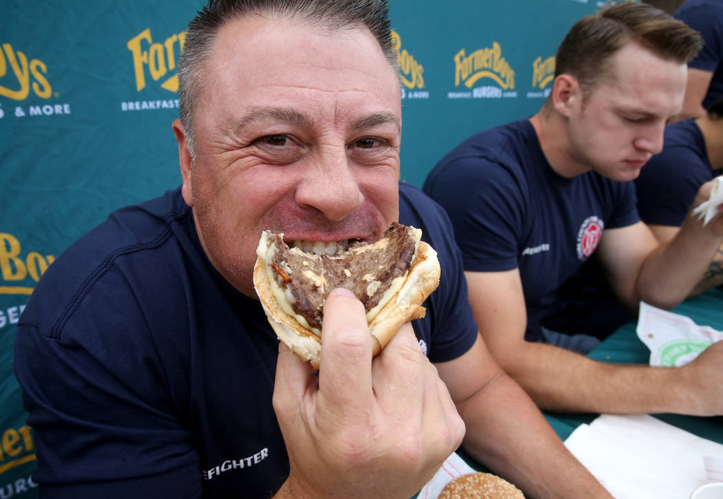 Clark County firefighters Erik Oliver, left, and Shane Salmon compete against Las Vegas firefig ...