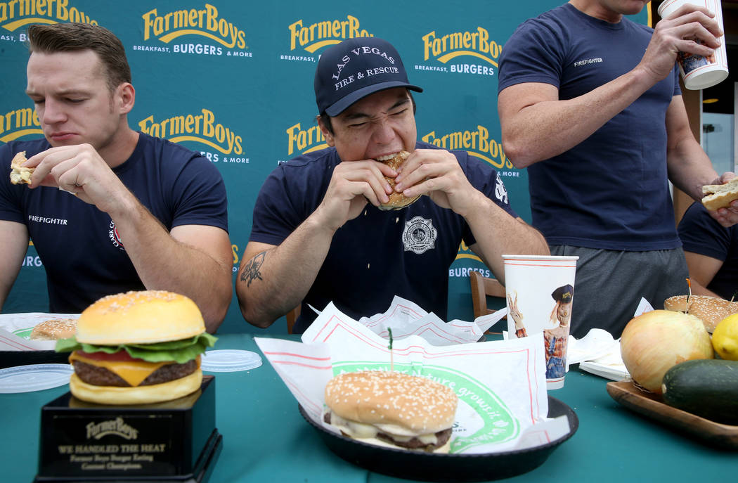 Clark County firefighter Shane Salmon, left, and his teammates compete with Las Vegas firefight ...