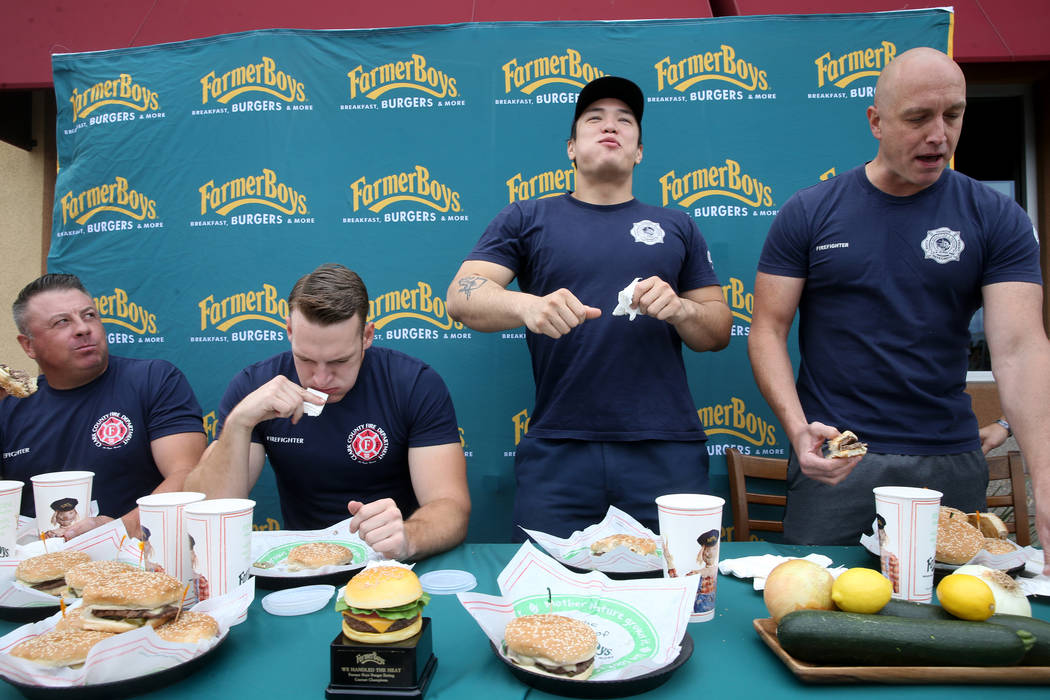 Clark County firefighters, from left, Erik Oliver and Shane Salmon compete with Las Vegas firef ...