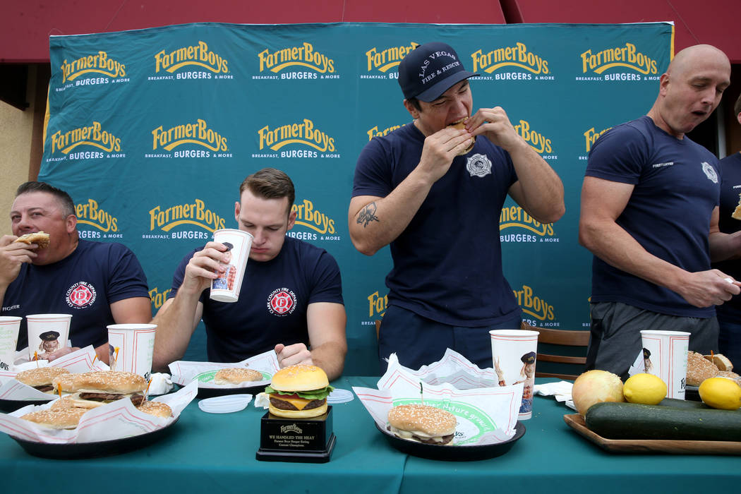 Clark County firefighters, from left, Erik Oliver and Shane Salmon compete with Las Vegas firef ...