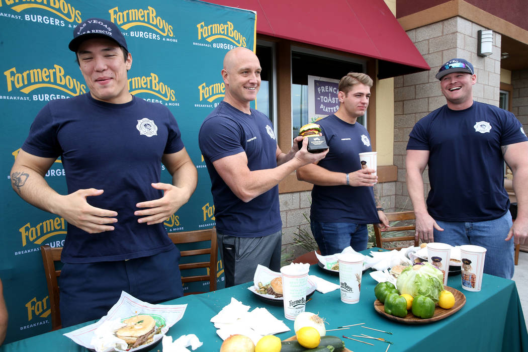 Las Vegas firefighters, from left, Toby Brown, Allen McFall, Kelby Lytle and Zach Lamboo celebr ...