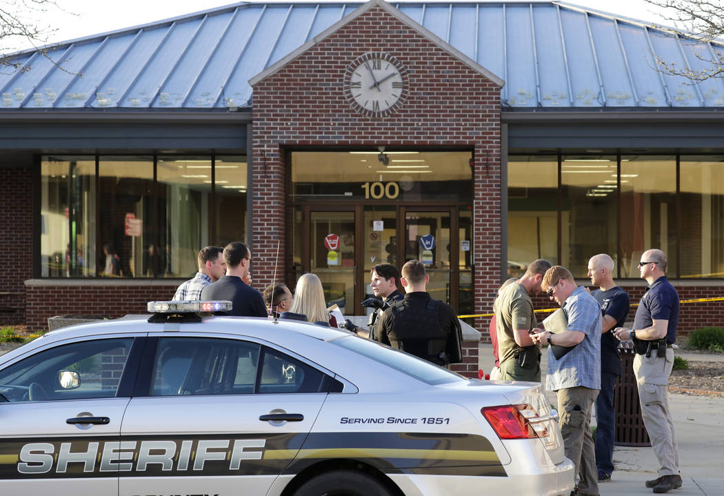 In this Wednesday, May 15, 2019 photo, authorities investigate the scene of a shooting at the V ...
