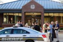 In this Wednesday, May 15, 2019 photo, authorities investigate the scene of a shooting at the V ...