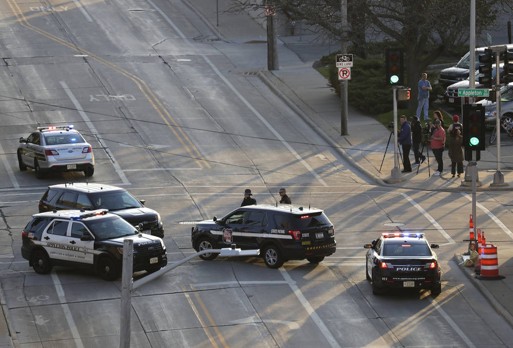 In this Wednesday, May 15, 2019 photo, authorities investigate the scene of a shooting at the V ...