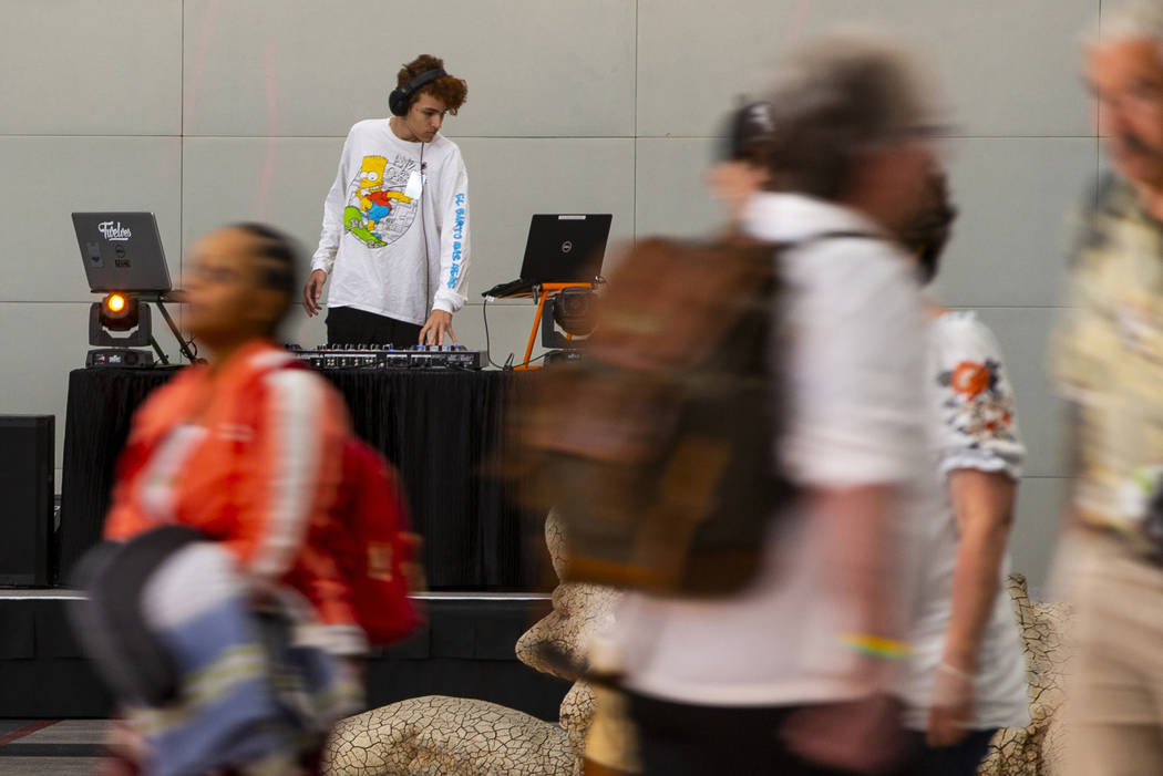 DJ SND BNDR plays for travelers including EDC visitors arriving through Terminal 3 at McCarran ...