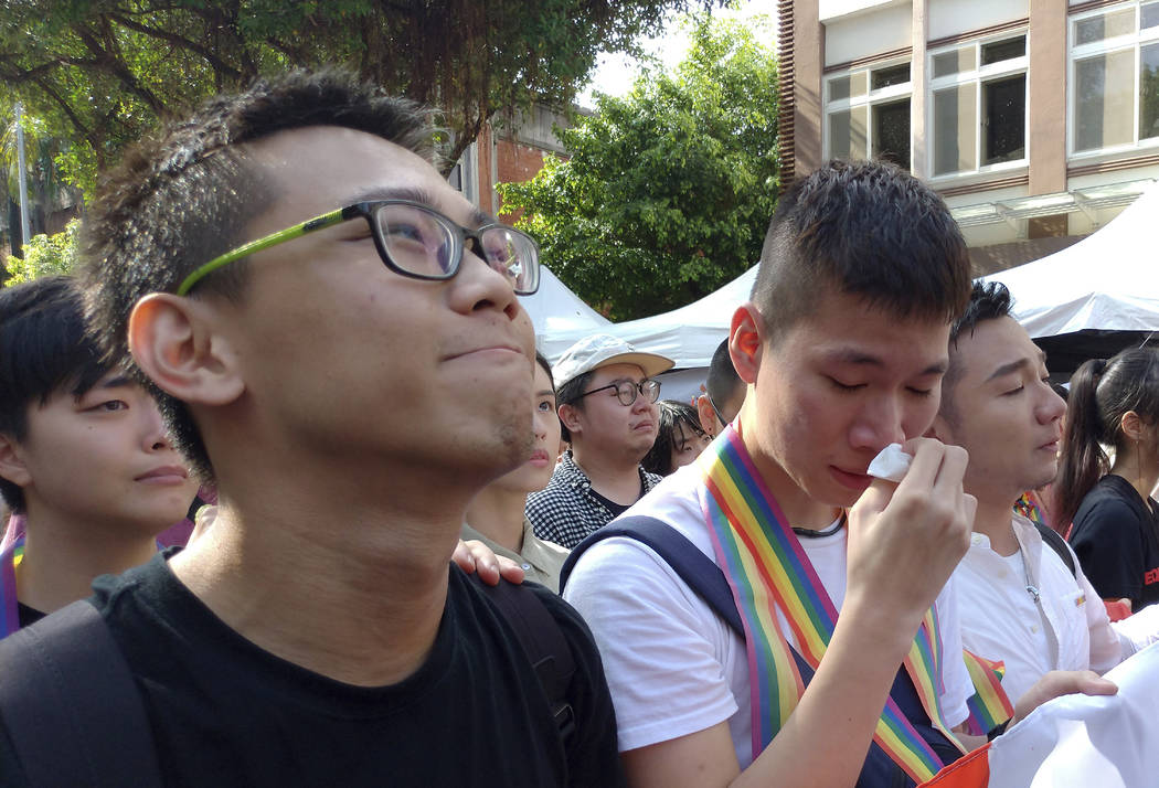 Same-sex marriage supporters cry in cheer outside the Legislative Yuan Friday, May 17, 2019, in ...