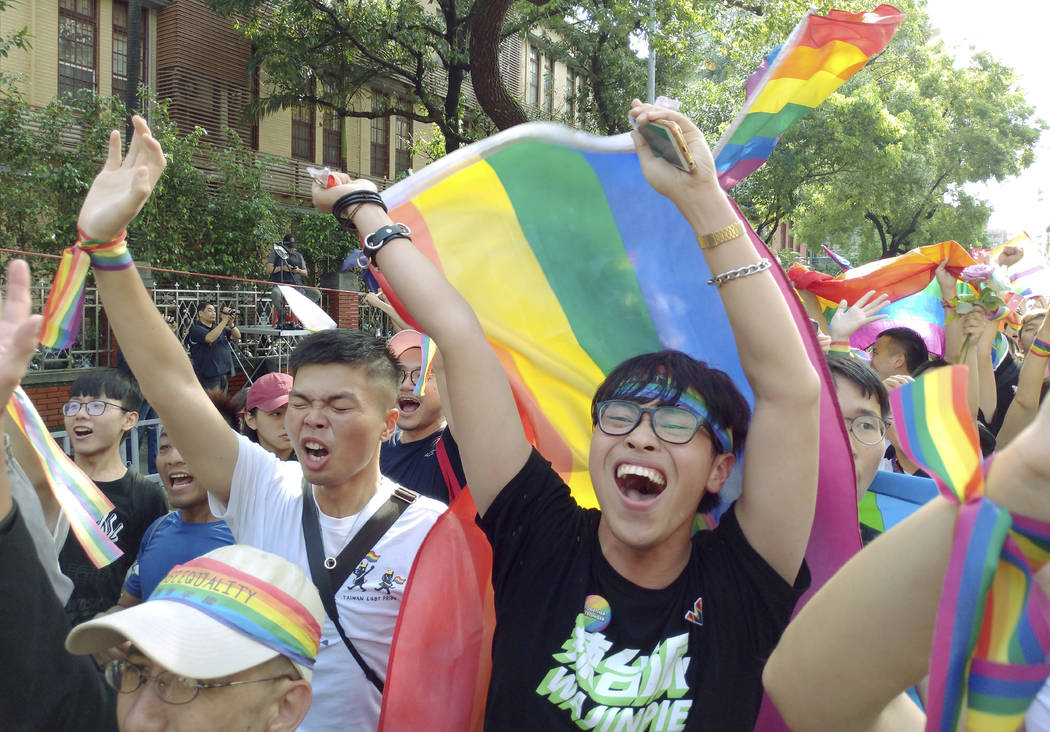 Same-sex marriage supporters cheer outside the Legislative Yuan Friday, May 17, 2019, in Taipei ...