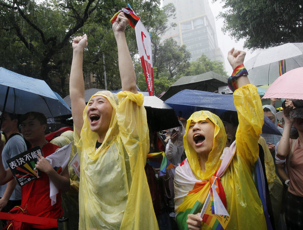 Same-sex marriage supporters cheer outside the Legislative Yuan in Taipei, Taiwan, Friday, May ...