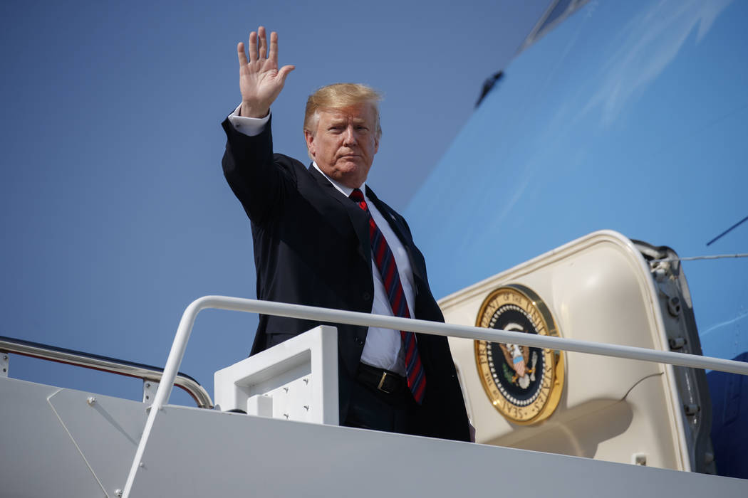 President Donald Trump waves as he boards Air Force One for a trip to New York to attend a fund ...