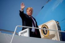 President Donald Trump waves as he boards Air Force One for a trip to New York to attend a fund ...