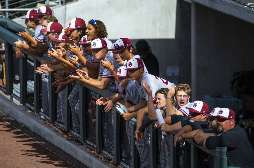 Desert Oasis players cheer on their teammate batting against Reno in the first inning during th ...