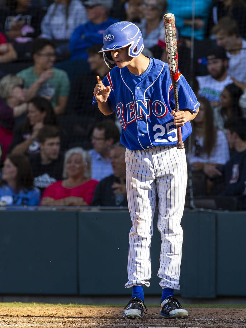 Reno batter Garryson Grinsell (25) takes direction from his coach versus Desert Oasis in the fo ...